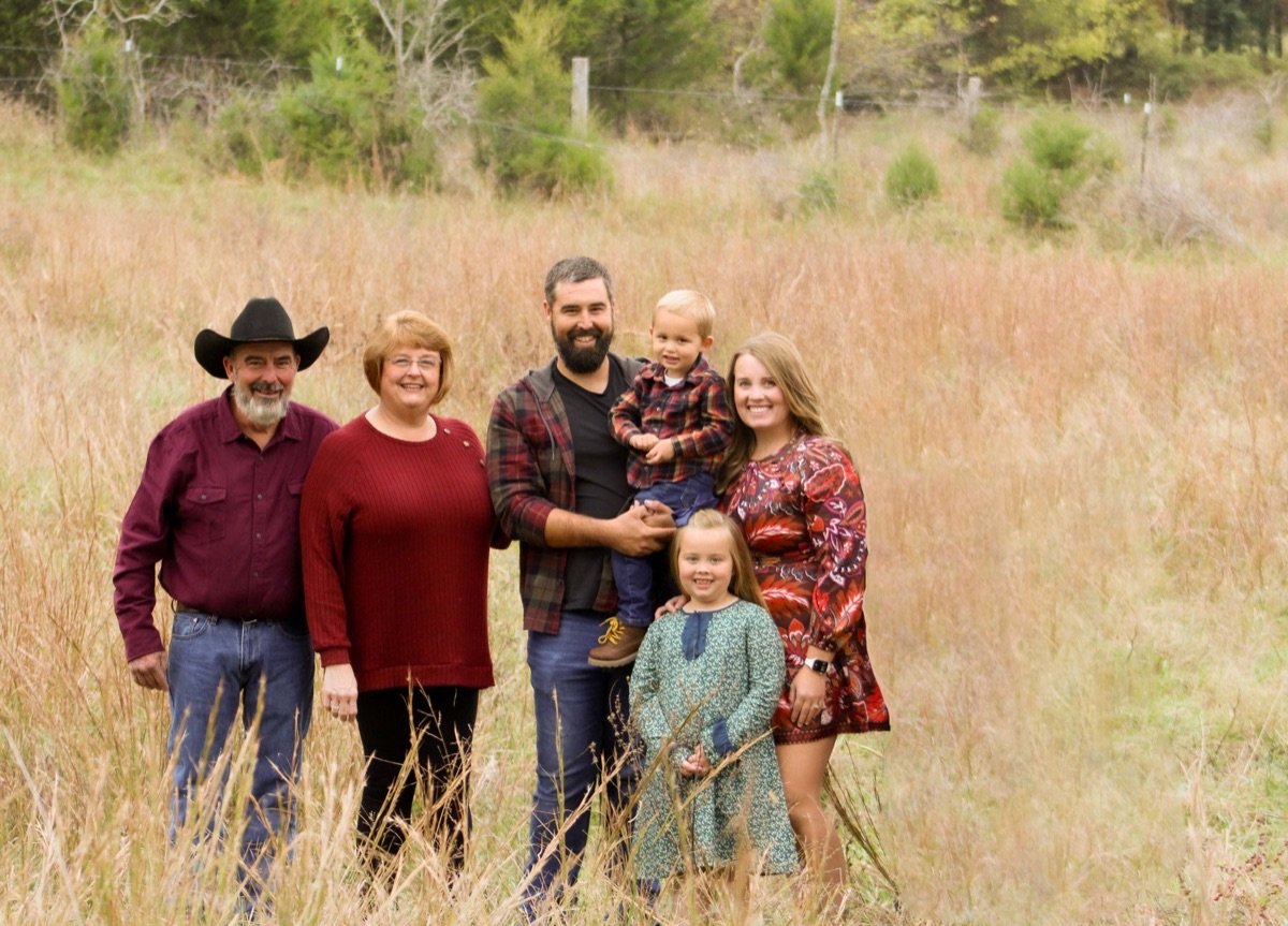 Three generations of the Cottrell family standing together in an autumn pasture on their Sonora, Kentucky farm